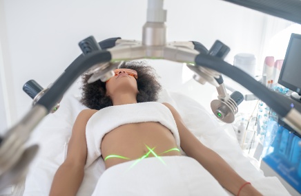 body-sculpting_436x285 woman laying on bed getting body sculpting