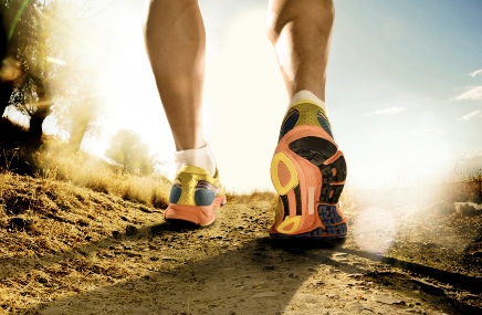 Fitness up close photo of runner shoes on trail
