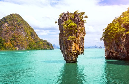 upright rocks standing in middle of ocean
